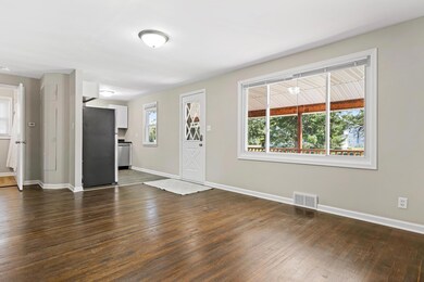 The living room is open to the kitchen and features a large picture window overlooking the covered front porch.  All of the windows have been replaced over the last 8 years.  Hardwood floors were just refinished.