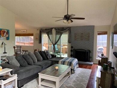 Living area featuring ceiling fan, wood finished 
