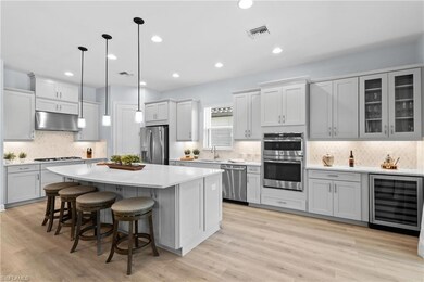 Living area featuring a tray ceiling, recessed lig