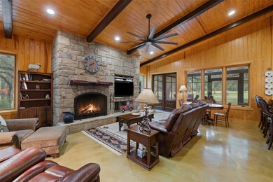 Living room with wood ceiling, ceiling fan, wood 