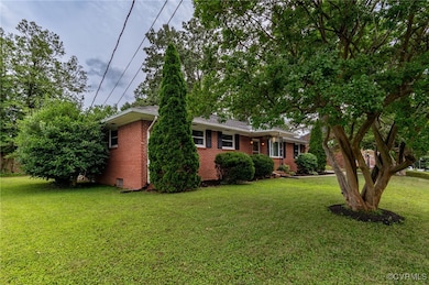 Ranch-style home with a front lawn and brick sidin
