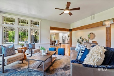 Living room featuring ceiling fan and wood finished floors