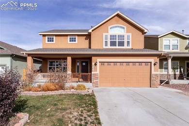 View of front of house with stone siding, covered porch, stucco siding, driveway, and an attached garage