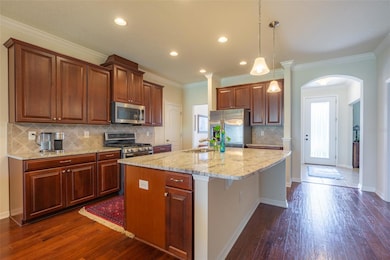 KITCHEN HAS ENGINEERED WOOD FLOORS & DECORATIVE BACKSPLASH & GAS COOKTOP