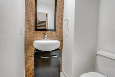 This stylish half bath is conveniently located on