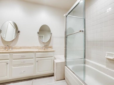 Full bath with double vanity, a sink, and shower /