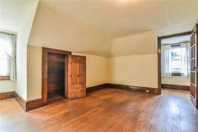 2nd level bedroom with exposed hardwoods, apx. 6'-