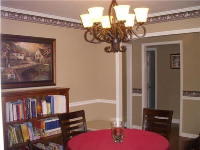 Formal dinning room with updated lighting fixtures and hardwood flooring and crown molding