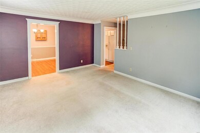 view from the living room into the dining (far left) and kitchen. Past that is the hall to the bedrooms.