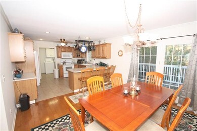 View from dining into kitchen. Bright open space.