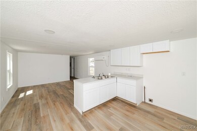 Kitchen with open floor plan, light wood-style flo