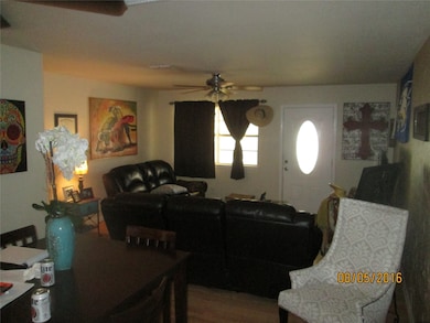Living room with ceiling fan and wood finished floors