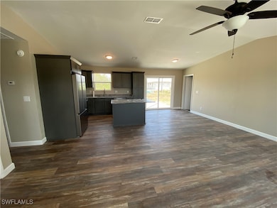 Kitchen featuring freestanding refrigerator, open