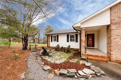 A gravel path leads you across a cute wooden bridge to a huge backyard!