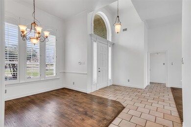 Inviting foyer with soaring ceilings and open to f