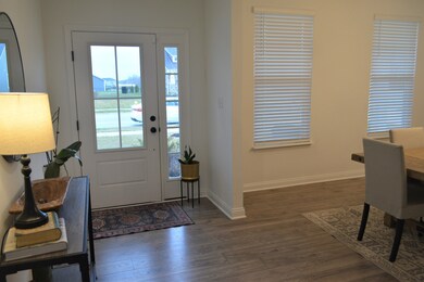 LVP flooring leads you into this very spacious home. Entrance to the formal dining room on the right.