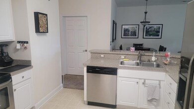 Kitchen featuring a sink, dishwasher, light counte