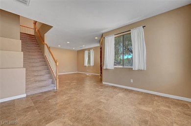 Empty room with stairs, baseboards, recessed light