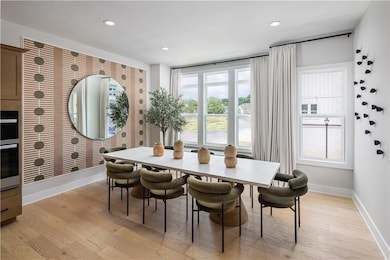 Dining area with light hardwood / wood-style floor