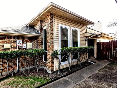 View of side of property featuring brick siding, a