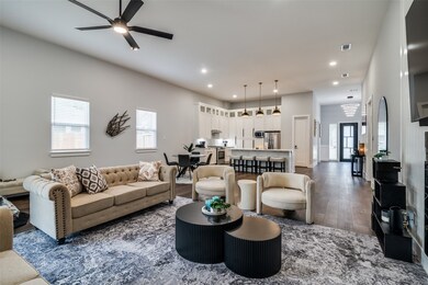 Living area featuring dark wood-style flooring, recessed lighting, and ceiling fan