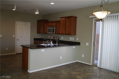 Kitchen featuring stainless steel appliances, dark