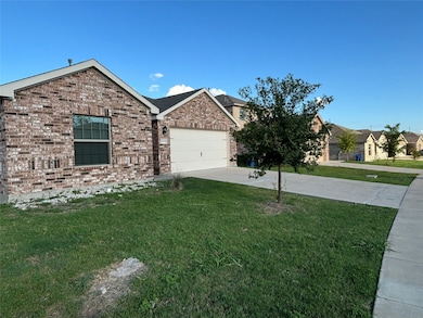 Ranch-style house featuring concrete driveway, a front lawn, an attached garage, and brick siding