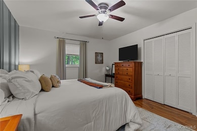 Bedroom with LVP, a ceiling fan, and a closet
