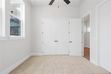 Corridor with ornamental molding and light hardwoo