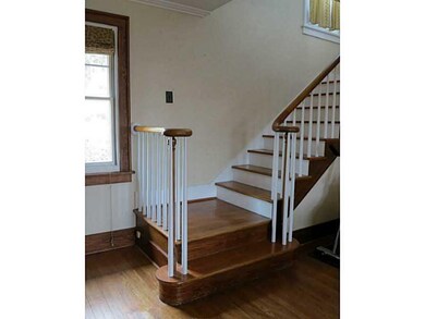Living Room. The staircase is set at the end of th