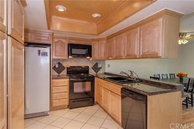 Double sink, recessed lighting, maple wood cabinet