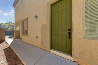 Doorway to property featuring a gate, stucco sidin
