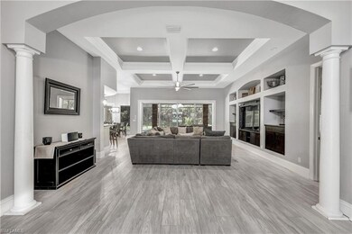 Living room with coffered ceiling, light hardwood 