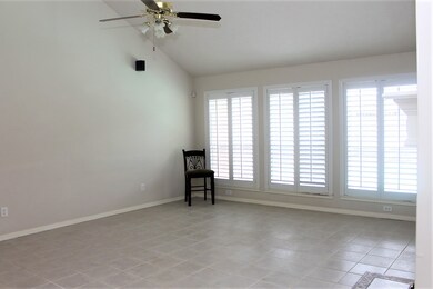High ceilings and tile floors. Windows with planta