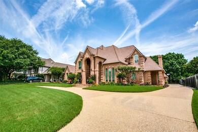 Stately circular driveway with gate to garages