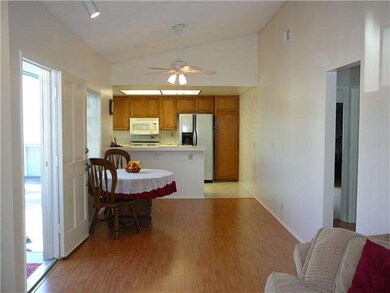 Vaulted ceiling & ceiling fan.  Big window over di