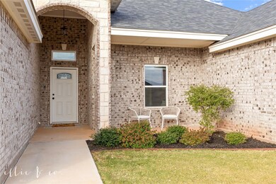 Front of home with landscaped  flower bed and sitt