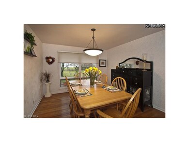Formal dining room with large windows and wood flo