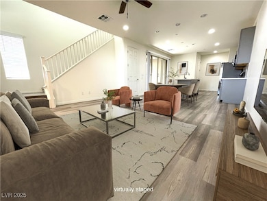 Living room featuring light wood-type flooring, ce