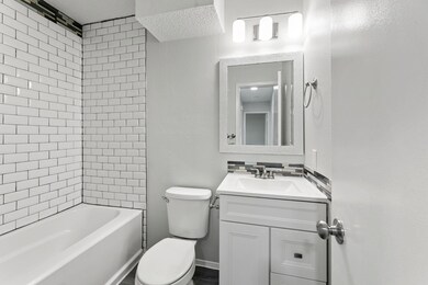 Full bath featuring vanity, toilet, and  shower c