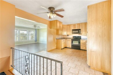 Kitchen with light brown cabinetry, ceiling fan, l