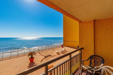 Balcony featuring a beach view and a water view
