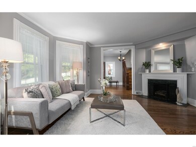 The living room features refinished hardwood, 9' ceilings, triple bay window and gas fireplace