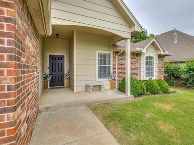 Property entrance with a lawn, brick siding, and roof with shingles