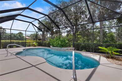 Large free form pool with water feature and landsc