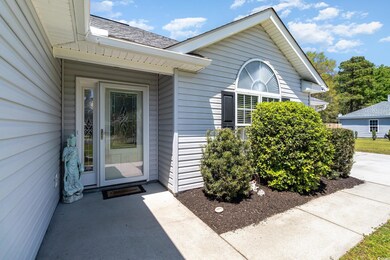 View of exterior entry featuring a shingled roof