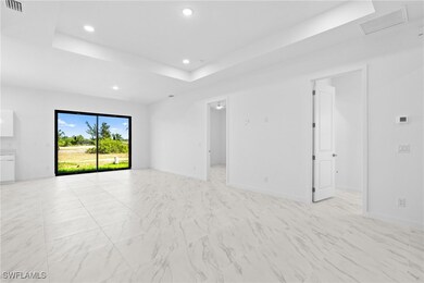 Spare room with visible vents, a raised ceiling, b