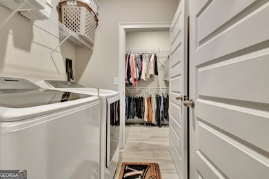 Laundry room directly connects to primary bedroom closet