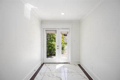 Bright entryway with double glass doors.