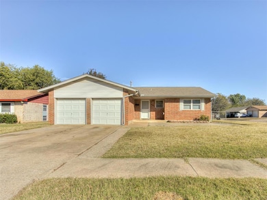 Ranch-style house featuring driveway, a front yard, brick siding, a shingled roof, and an attached garage